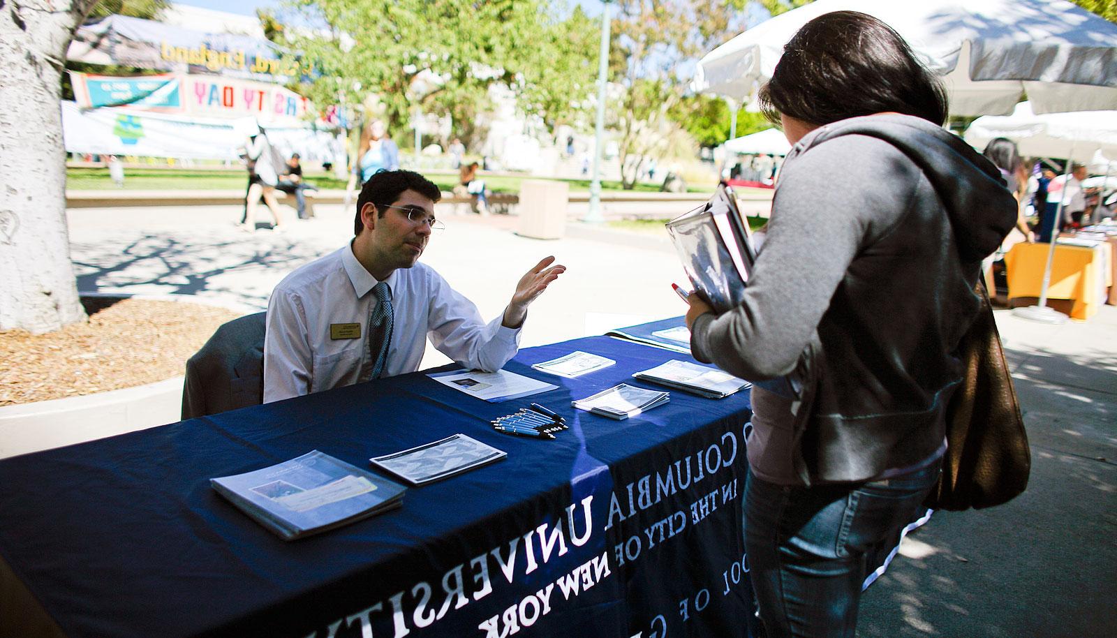 A student speaks with a representative from Columbia University.